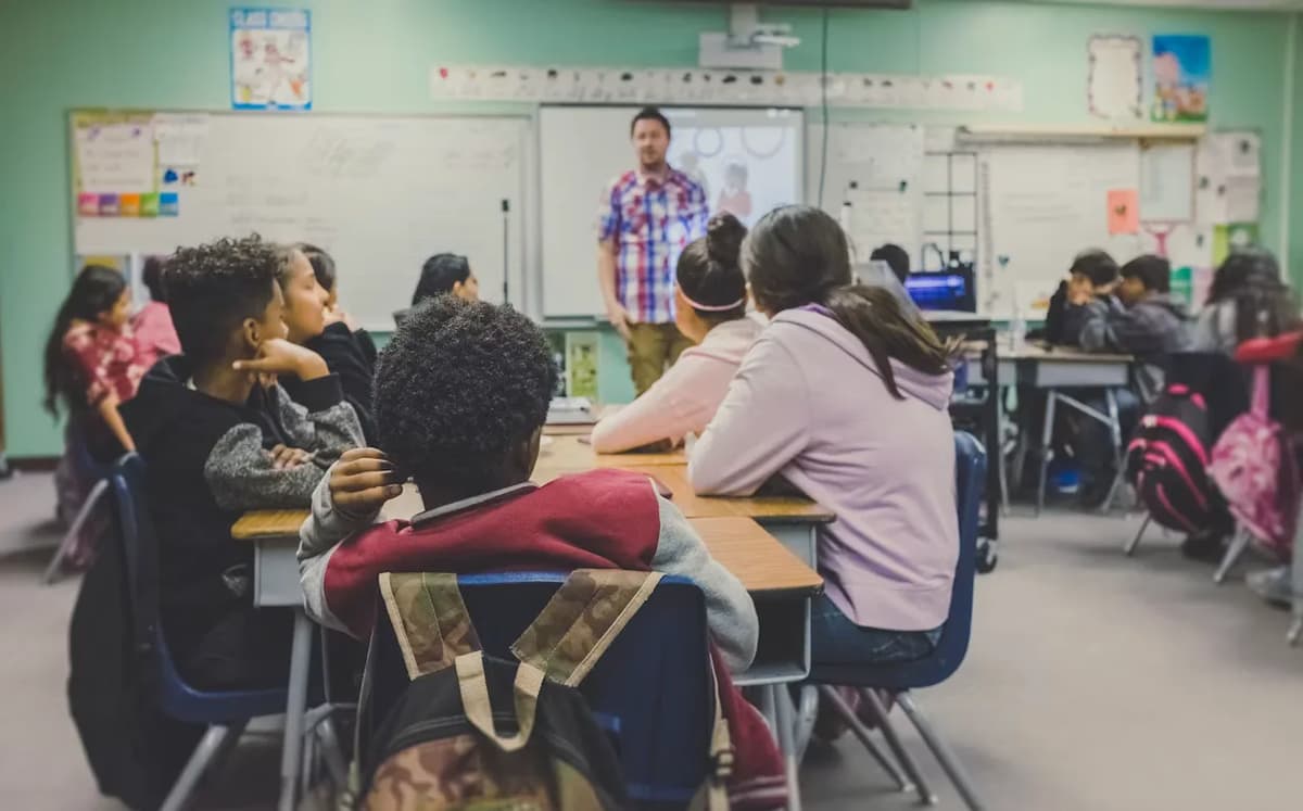 Teacher leading a classroom lesson while students listen at their desks