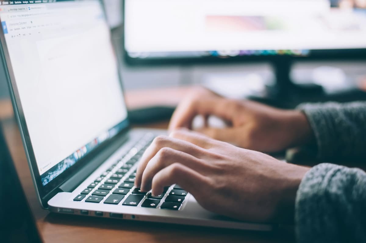 Professional typing on a laptop during a focused learning session