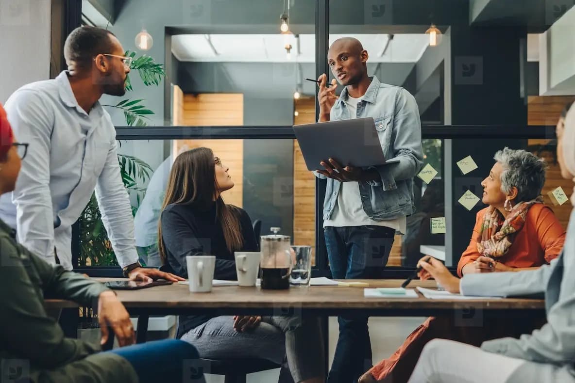 Business development team meeting in 2026 discussing AI-driven growth strategy, partnership planning and revenue forecasting in a modern office environment