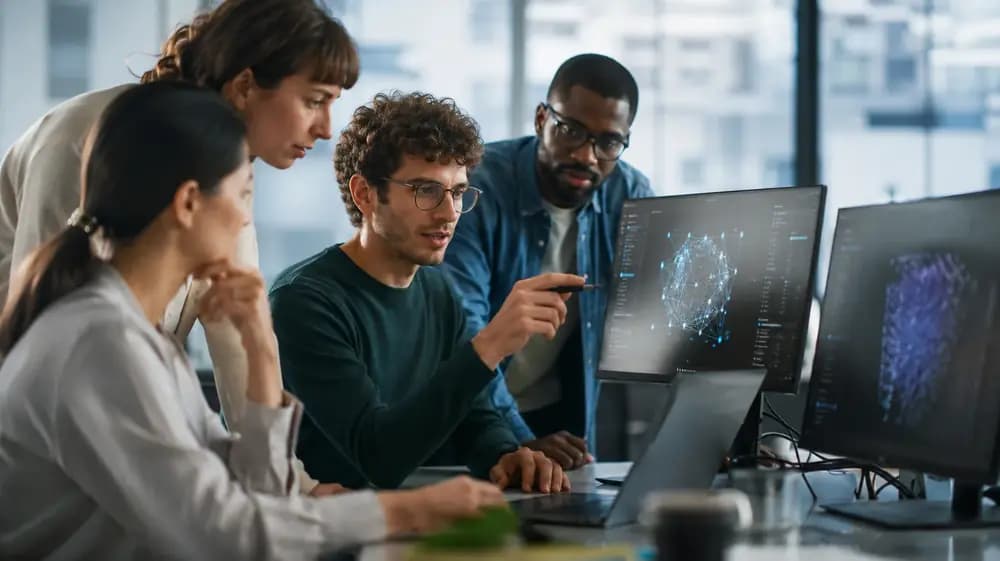AI developers collaborating on machine learning software in a modern office