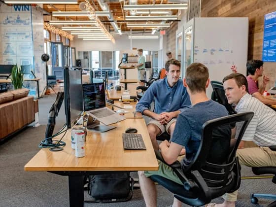 Software developers collaborating in a modern tech office, reflecting the teamwork behind API development