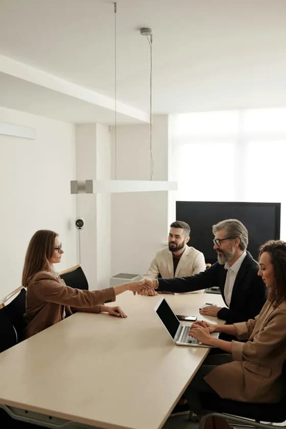 Business professionals exchanging a handshake after a successful deal – a common outcome of effective business development partnerships