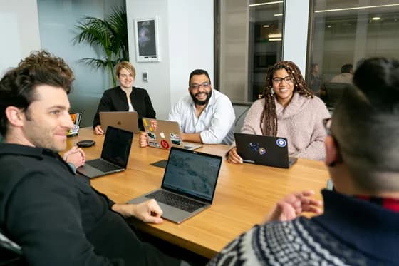 A modern business team collaborates on data analysis, reflecting the rising importance of Business Intelligence in 2026. BI teams today work closely with various departments to drive data-driven decisions and strategy.