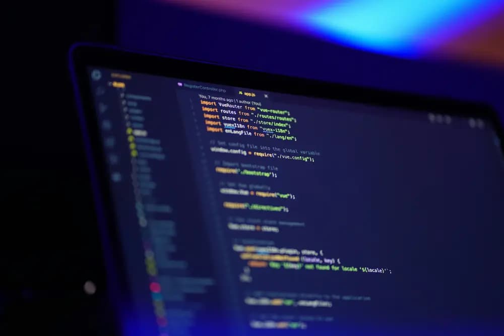 Close-up of a laptop screen displaying cloud application source code in a dark-themed development environment