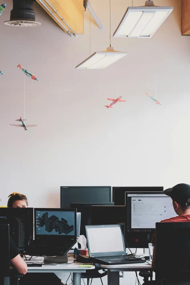 Two cloud engineers collaborating on a project. In 2026, cloud security engineering often means working closely with colleagues to embed security at every step of development and operations. Teamwork and knowledge-sharing are essential to stay ahead of evolving cloud threats.