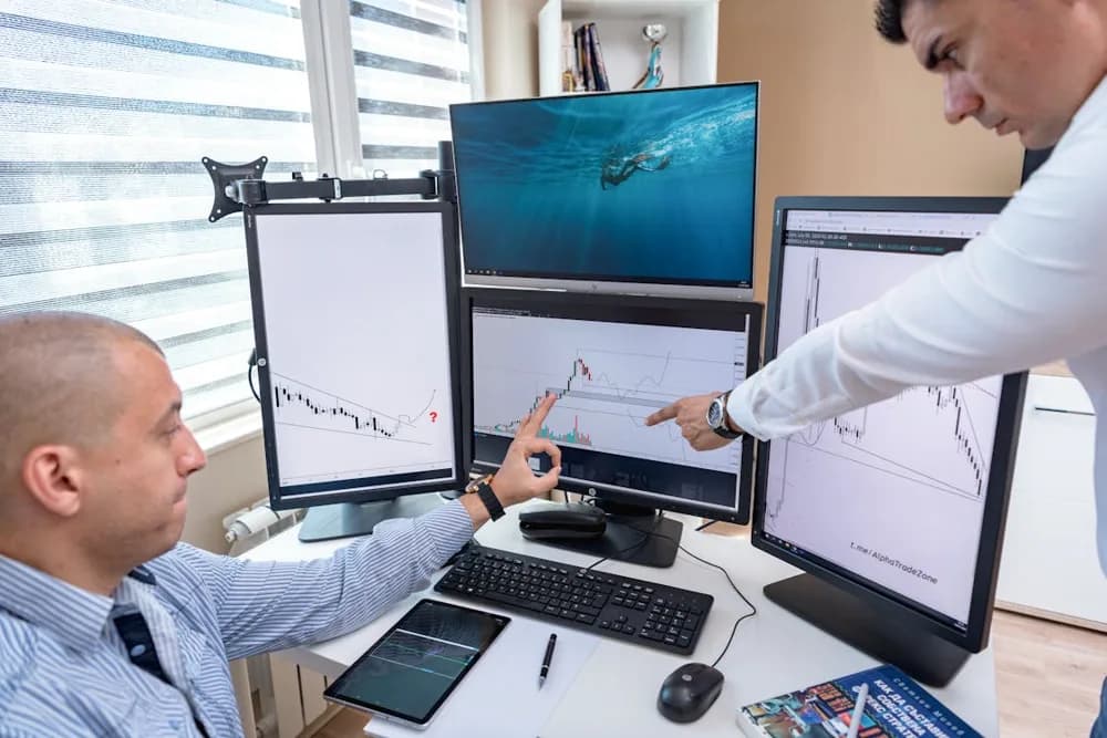 Two professionals analyzing data on multiple screens, reflecting the collaborative and tech-driven nature of data analytics in 2026.