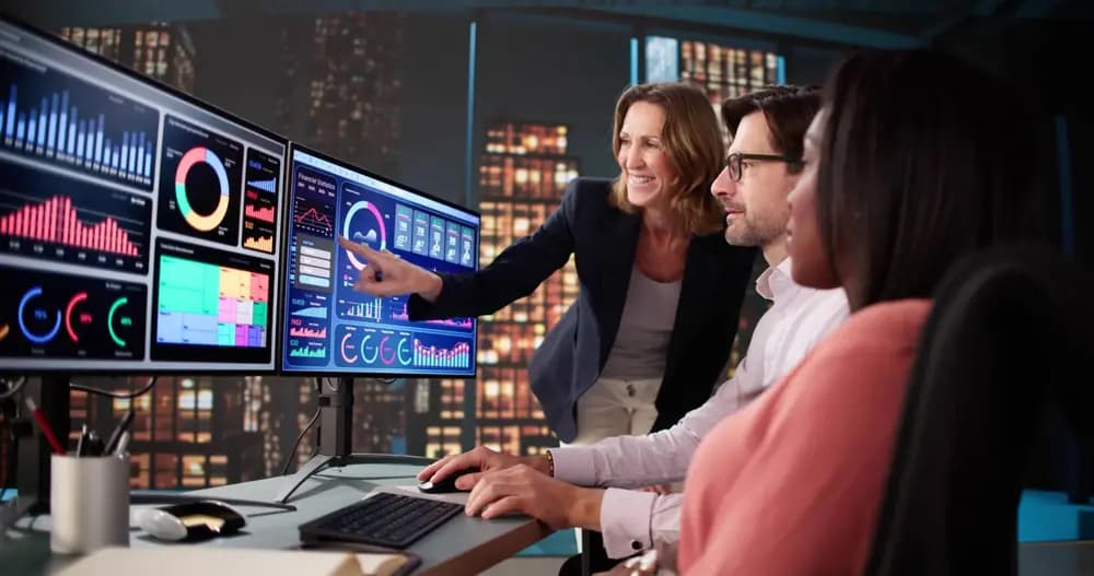 Data science team analyzing dashboards and machine learning metrics on multiple screens, illustrating real-world data-science-program in 2026 with business intelligence and predictive analytics workflows