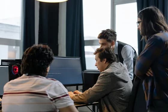 DevOps engineers collaborating on cloud infrastructure configurations. In 2026, real-world teamwork and Infrastructure as Code tools like Terraform help teams deploy and manage systems efficiently
