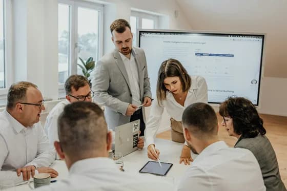 A DevOps team collaborating in an office environment. In 2026, DevOps engineering teams are more cross-functional than ever, developers, operations, and security working together to automate and streamline software delivery.