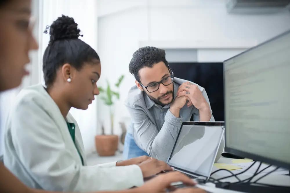 DevSecOps and platform engineers collaborating on secure software delivery, reviewing code and infrastructure to integrate security into modern DevOps workflows.