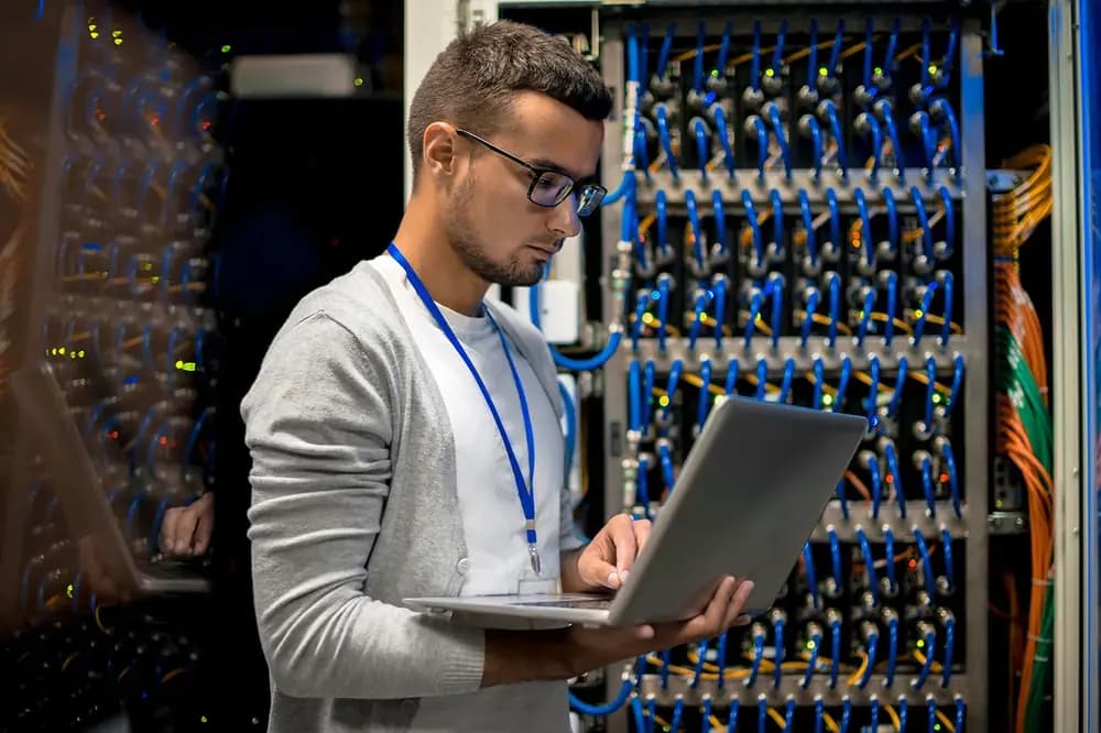 A student working on a laptop, practicing SQL queries to prepare for a Database Administrator internship, with a career roadmap in the background.