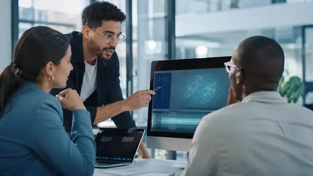 Professionals collaborating on prompt-engineering and AI workflow strategy in a modern office