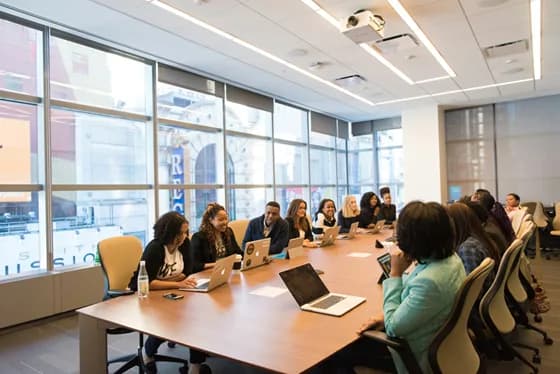Prompt engineers collaborating in a modern office  integrating human expertise with AI-driven tools.