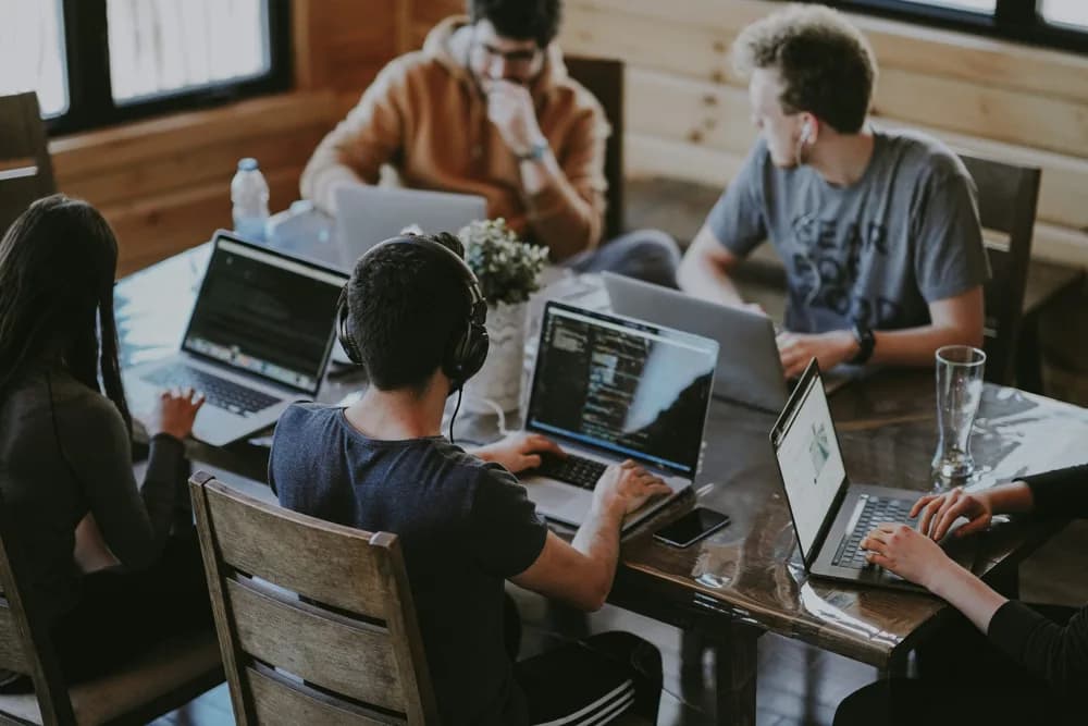 Real professionals collaborating on AI projects using prompt engineering techniques at Refonte Learning