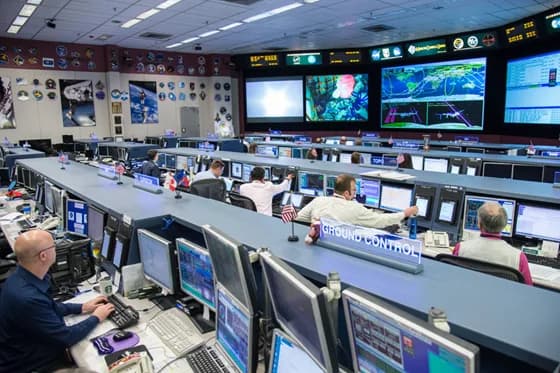 Flight controllers (satellite operations specialists) at NASA’s Mission Control Center monitor a mission. Satellite operations roles involve real-time teamwork to manage spacecraft and ensure mission success