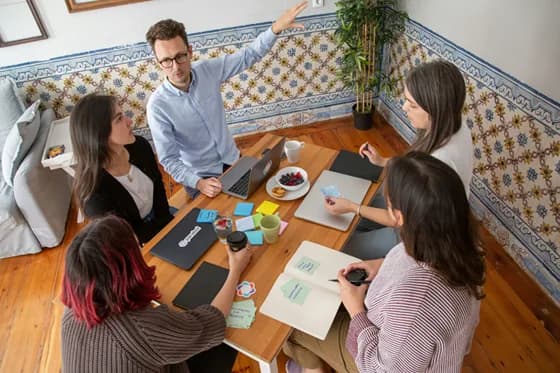 Scrum Masters facilitate effective team collaboration – here a Scrum Master leads a planning meeting, ensuring everyone stays aligned on goals and impediments are addressed. In 2026, such servant leadership and coaching are more vital than ever for high-performing Agile teams.