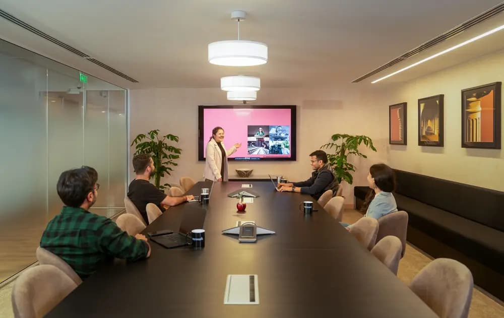 Social media manager 2026 presenting AI-powered marketing analytics and revenue growth strategy to team in professional conference room setting