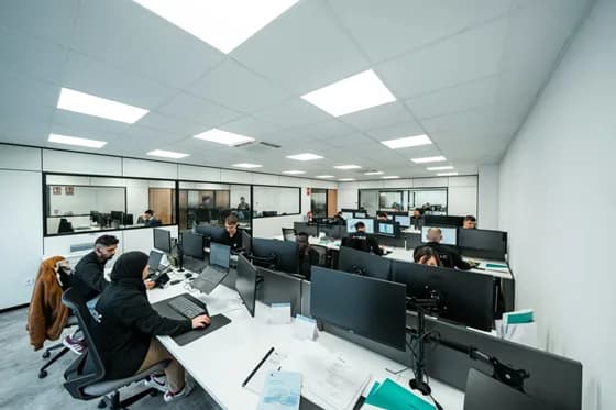 A team of software engineers collaborates in a modern office setting. In 2026, successful development relies on teamwork using advanced tools – from AI-powered coding assistants and cloud platforms to robust DevOps pipelines. Refonte Learning’s approach emphasizes project-based learning with the very tools needed for today’s software challenges.