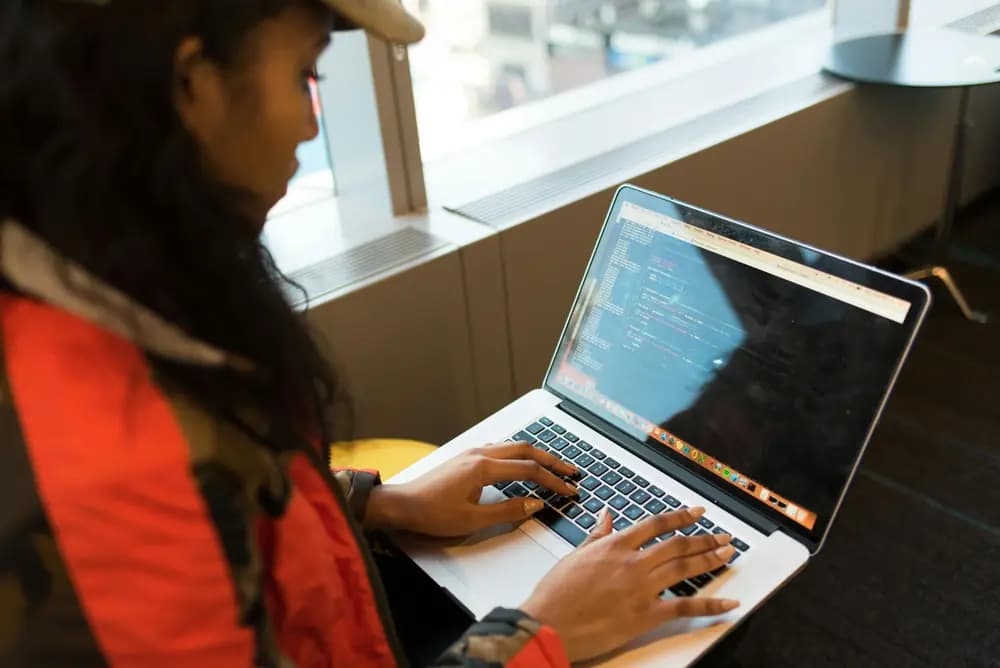 Backend development engineer writing server-side code on a laptop, building scalable and secure backend systems for modern applications.