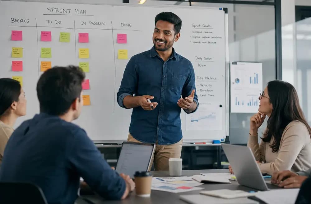Scrum Master facilitating sprint planning with an agile team in a modern office